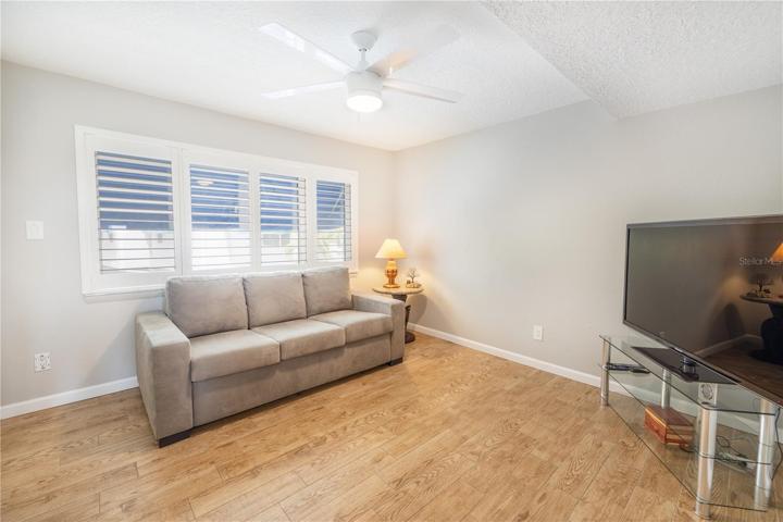 Second bedroom has plantation shutters and is being used as a TV room