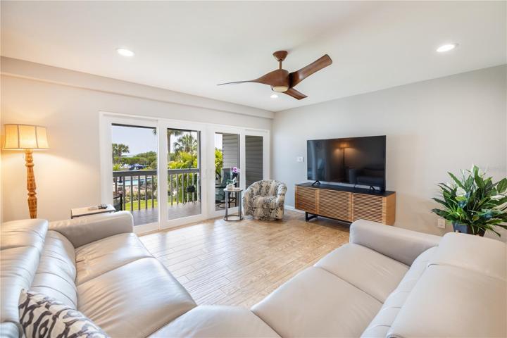 Living room with a view of the open green space and boat slip #12