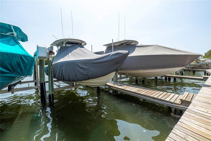 Boatslip with remote control, dedicated electrical panel, wrapped pilings and both motors replaced in 2019