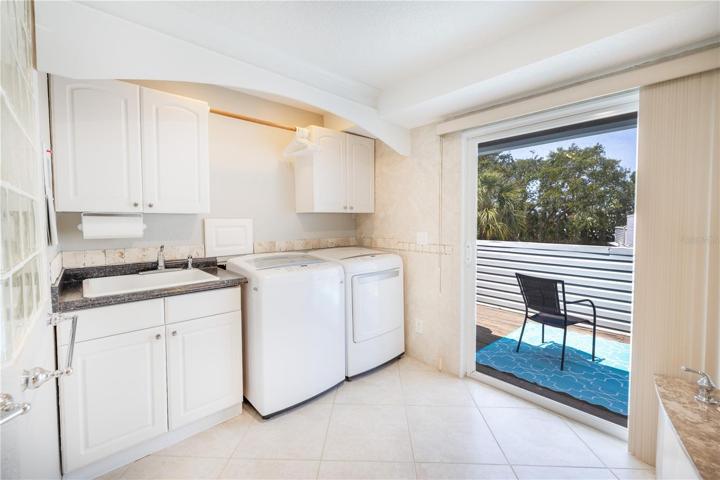 Laundry area with full size LG washer and dryer and laundry tub is located in the owner's bathroom. There are sliding doors to a private sundeck.