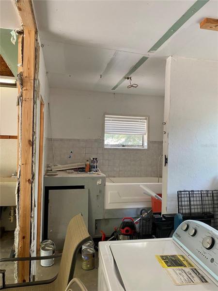 Unfinished garage bath, with water heater.