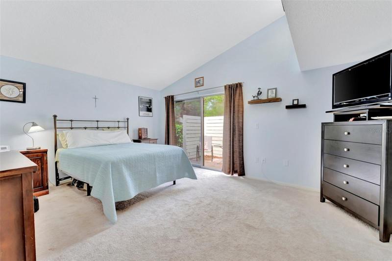 primary bedroom with sliders out to patio