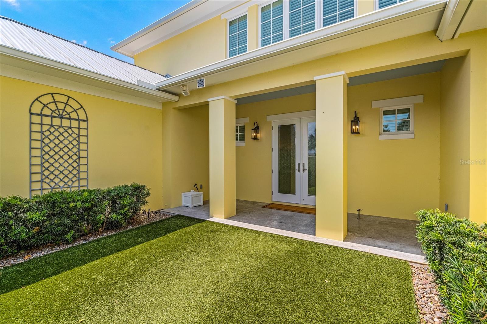 Welcome Home! Gated courtyard with artificial turf and tailored landscape welcomes you and your guests.