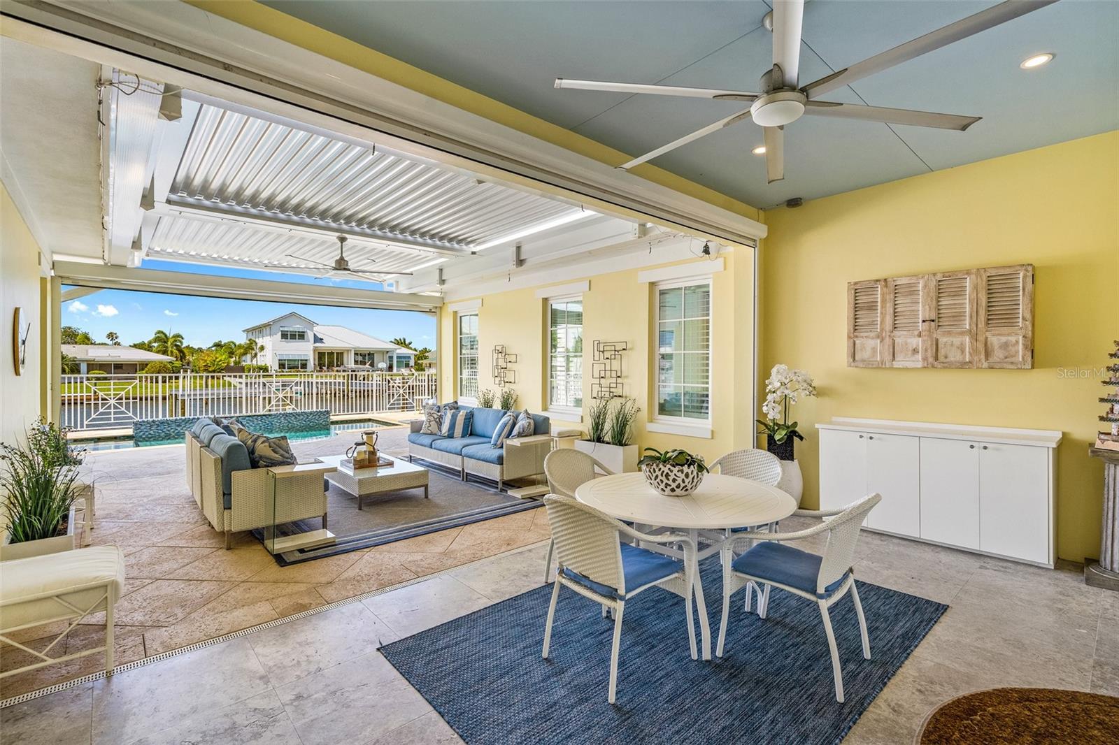 Have a seat outside and enjoy the cafe' or the conversational area. Stay cool with 2 "Big Ass" brand ceiling fans. The coral tiles will keep your feet cool and the remote controlled louver ceiling allows you to choose sun or no sun. The roll down screen between the cafe and the seating does not allow mosquito's to enter when closed and closes off the home, as well, so you can keep the doors open on a nice day. The roll down between the pool and the sofa area is made of Kevlar. For storm/wind protection. A mosquito spraying system to ward off pests.