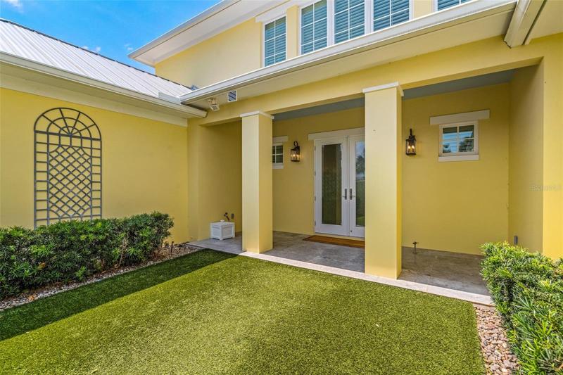 Welcome Home! Gated courtyard with artificial turf and tailored landscape welcomes you and your guests.