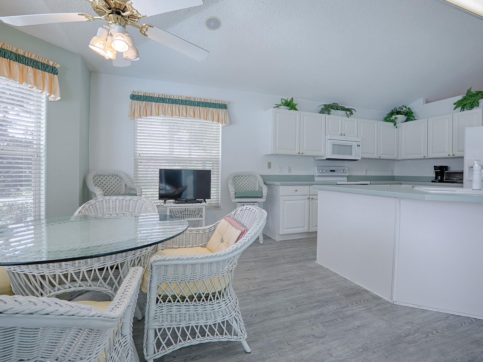 CASUAL DINING AREA WITH BAY WINDOW.