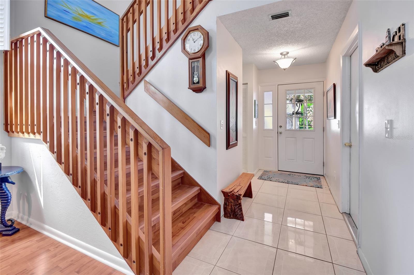 Stairwell to second floor. Front door and 1/2 bath afar.