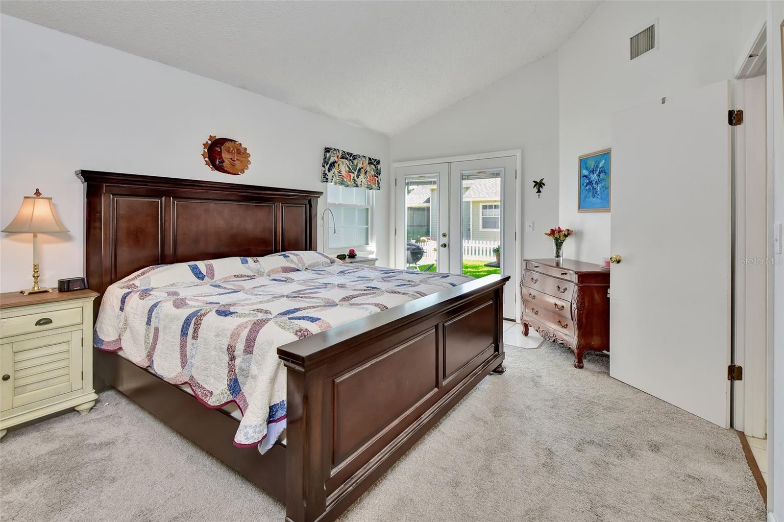 Owner's Suite towards French Doors and fenced rear courtyard.