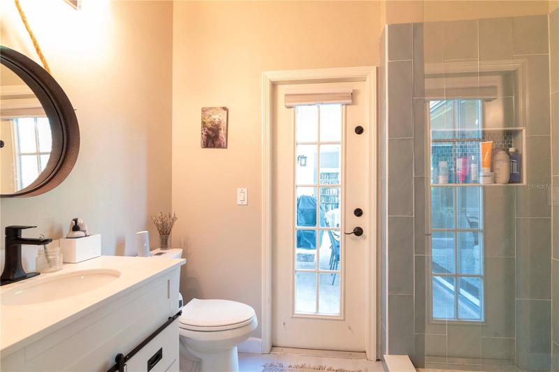 Second master with walk -in shower - leads out to the patio (pool bath)