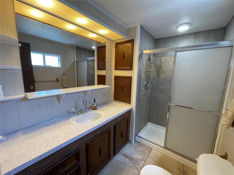 Full bathroom with tiled walk in shower.