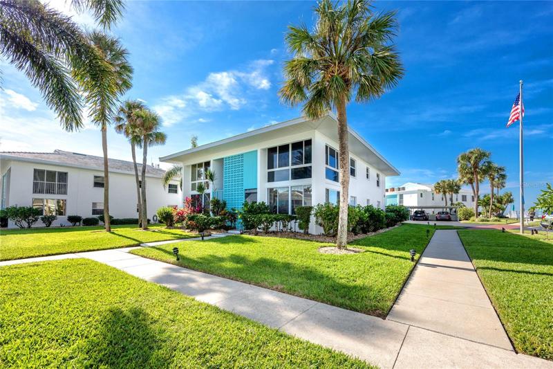 Side view of the condo on the 1st floor. Carport parking on the way to the beach.