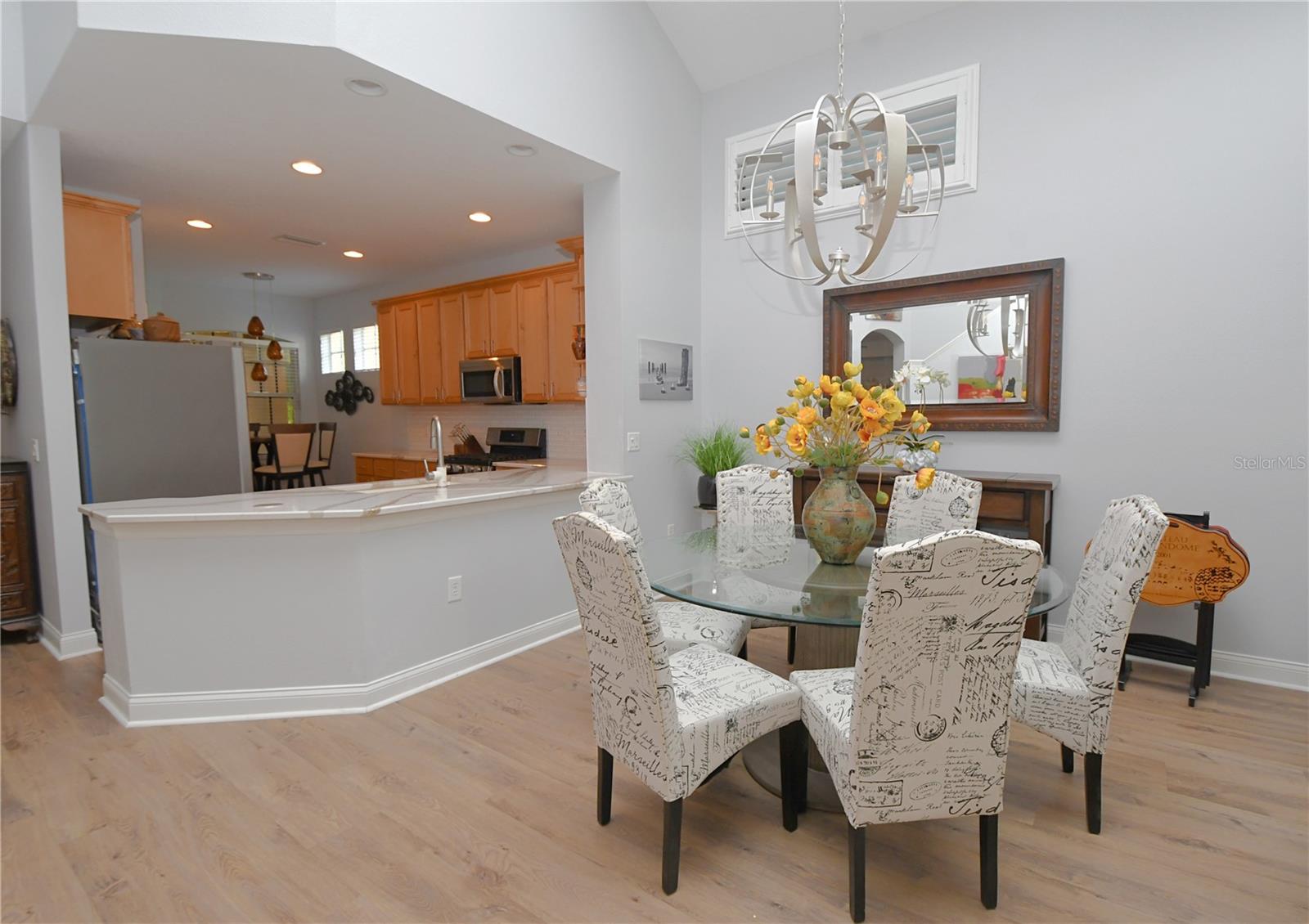 The dining room shines with a contemporary chandelier hanging above the table, crafting an ideal space for entertaining.