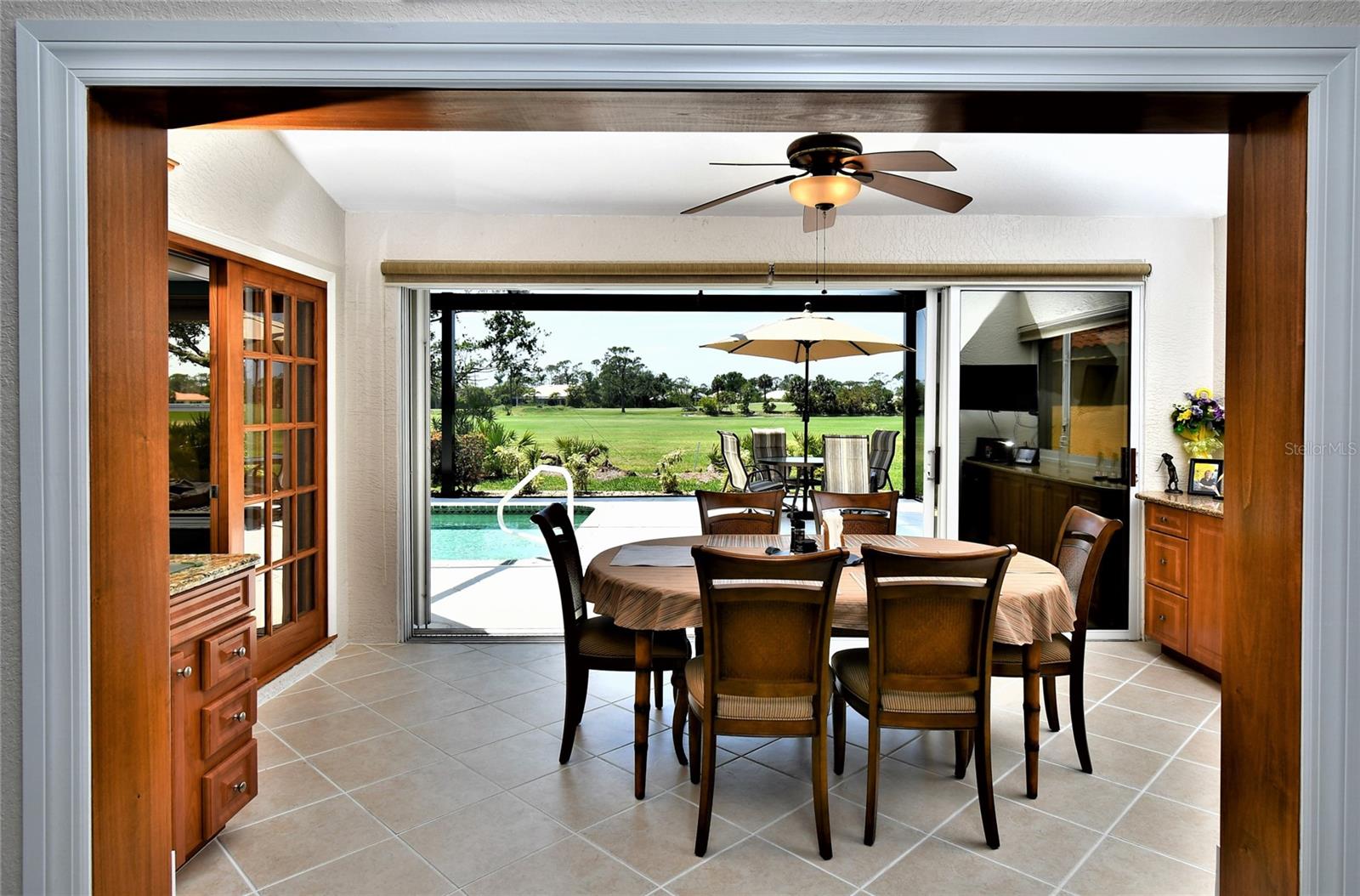 This Florida Room will wow you! Lined up perfectly with the picture window pool cage you have an almost unobstructed view to the great outdoors! Serving your poolside meals does not get easier than this convenient multi purpose space.