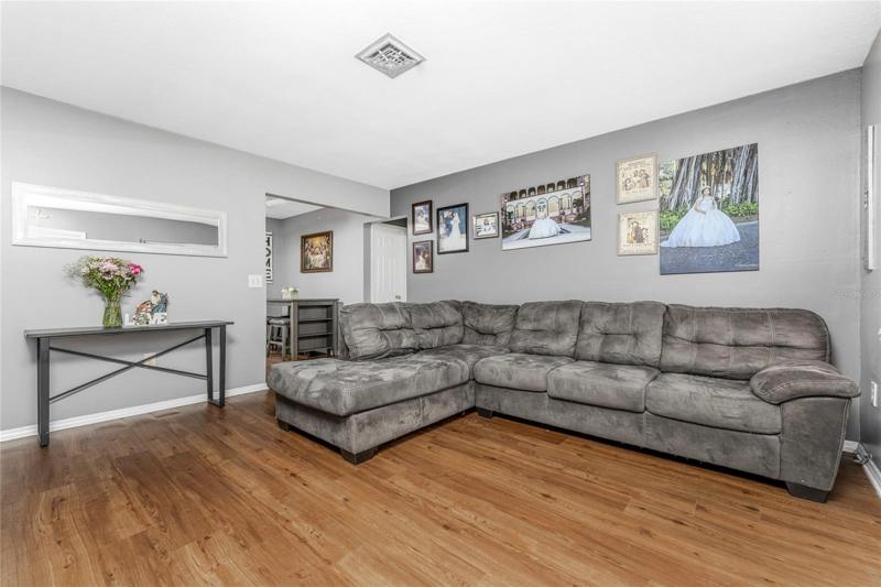 Another view of living room looking toward kitchen/dining area