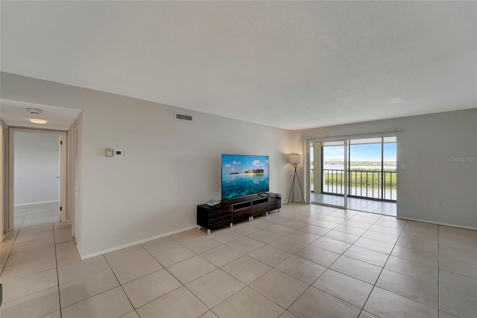 Dining and living area with sunrise views over the bay and preserve