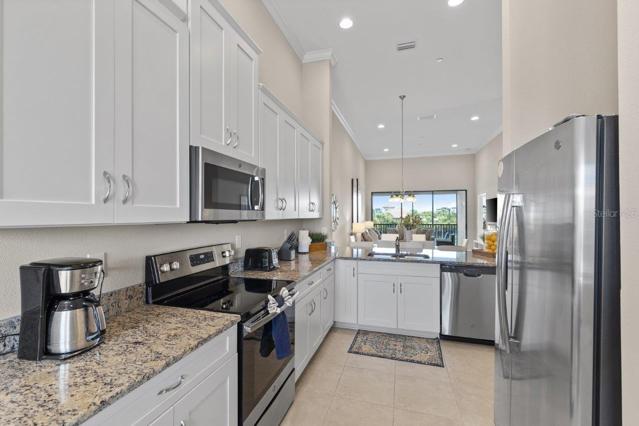 Stunning Kitchen off the front entryway featuring, 12'+ Ceilings, ample cabinetry, granite counter tops, and stainless steel appliances