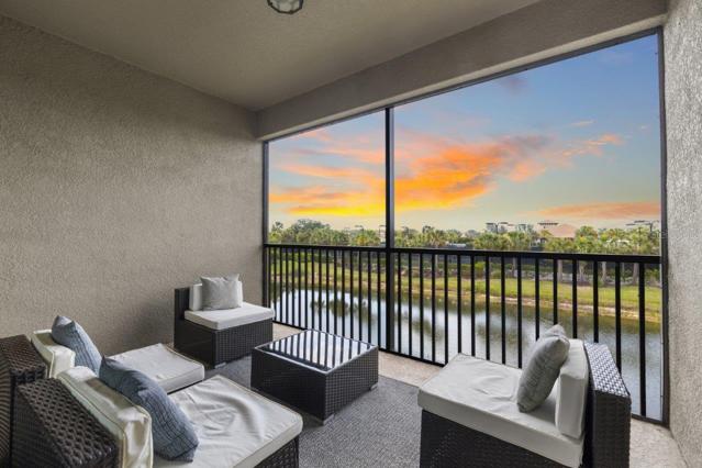 Large screened-in covered lanai with lake and amenities center views