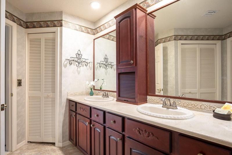 Dual sinks, CUSTOM cabinetry with plenty of counter space for dressing and storage. Stone counters and plenty of closet space too.