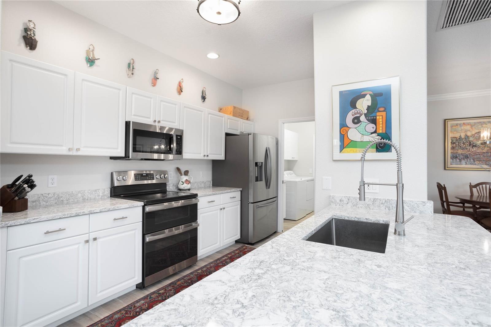 Kitchen with Cambria quartz counters, center island and stainless appliances