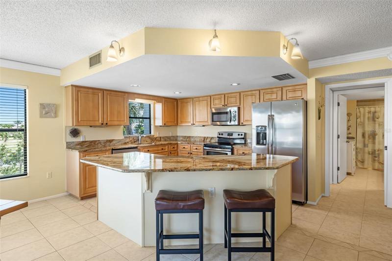 Kitchen with Stainless Steel Appliances & Window.