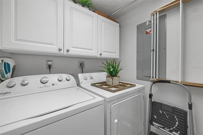 Washer/Dryer in Laundry Room with overhead cabinets.
