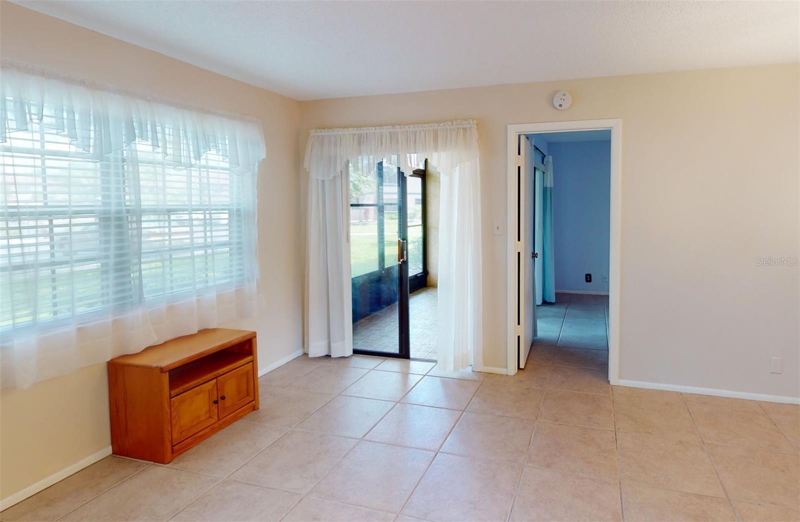 Living room, leading to lanai and master bedroom.