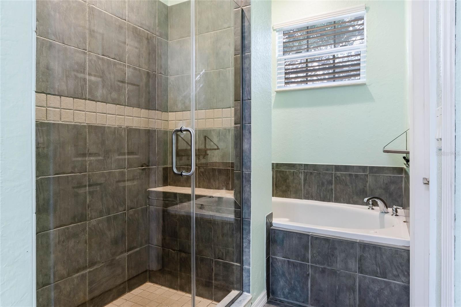 Primary Bath features a double sink, shower and soaking tub