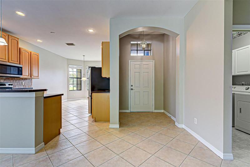 FROM LIVING ROOM LOOKING AT FRONT DOOR AND KITCHEN
