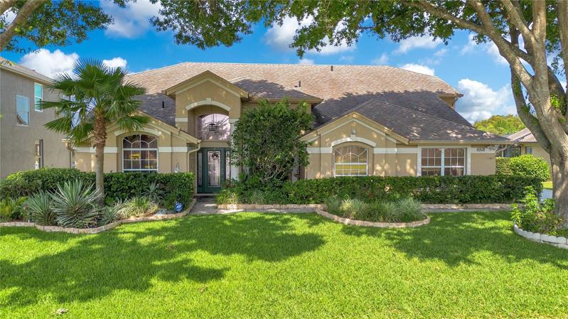 Lush landscaping and inviting covered entry way.