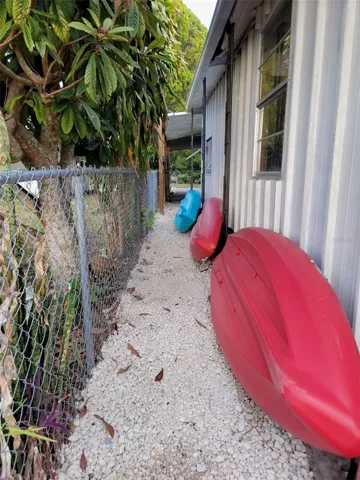 Behind the workshop area and beyond the carport.