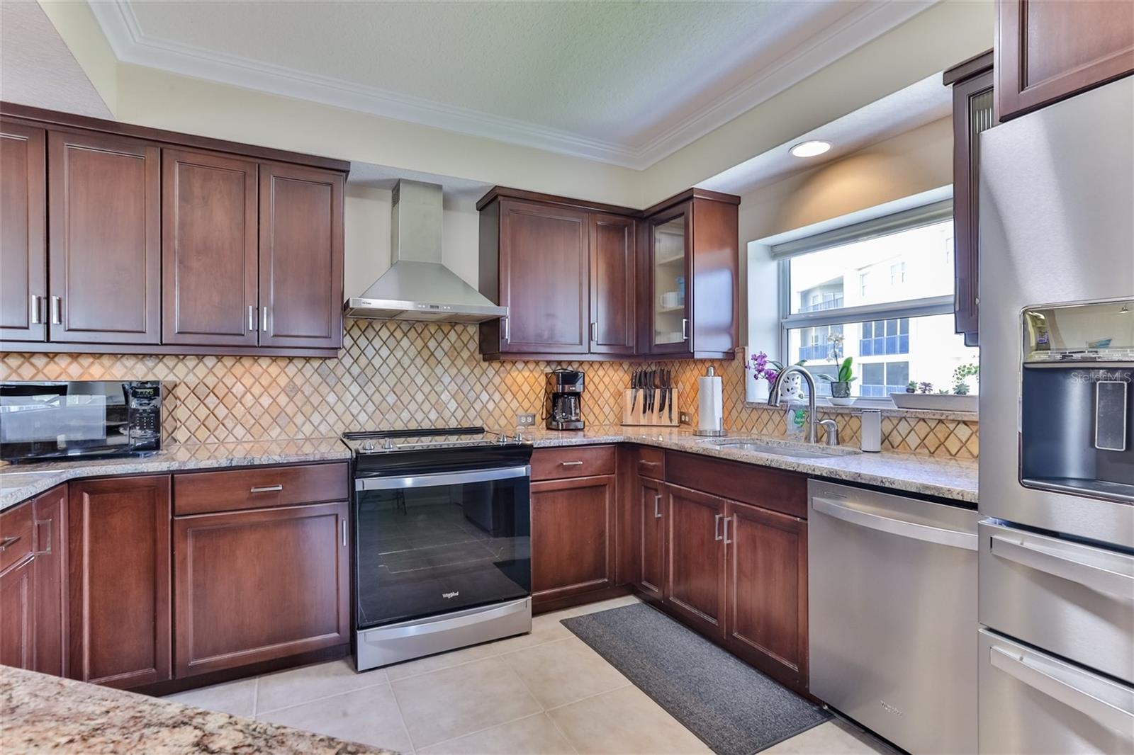 Kitchen with raised tray ceiling, abundance of cabinetry and new Whirlpool applicances.