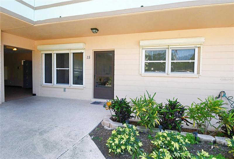 Front of the condo unit #15 that is conveniently located on the 1st floor. Beautiful landscaping upfront!Hurricane proof windows come with electric hurricane shutters!