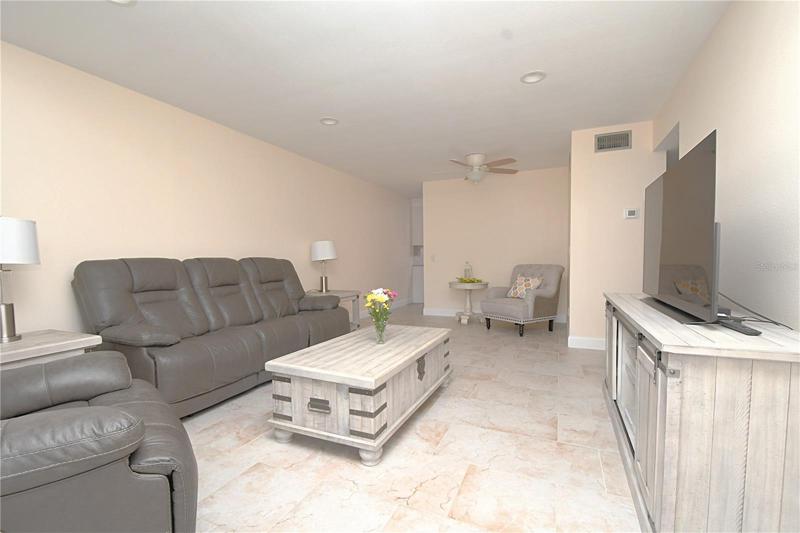 Living room area - new ceramic tile, recessed lightning and a ceiling fan/light