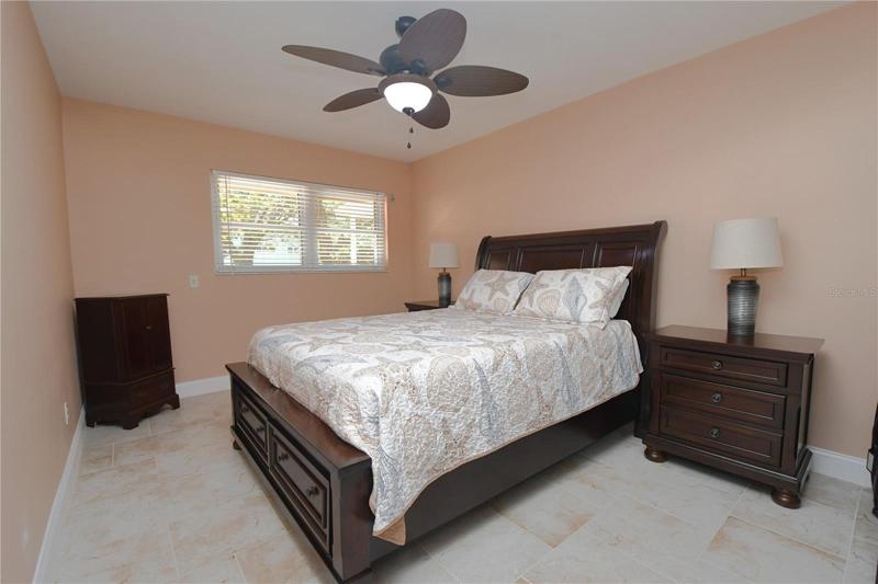 Master bedroom featuring a ceiling fan with a light.