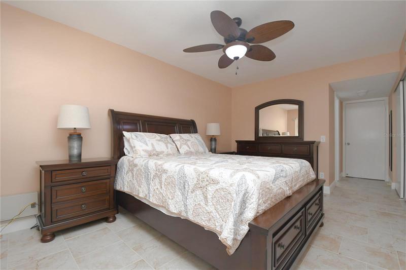 Master bedroom featuring a ceiling fan with a light, long 12x2 build-in closet and en-suite bathroom.