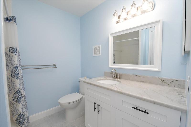 Master bathroom - new vanity with a sink and make-up area. There is a walk-in shower.