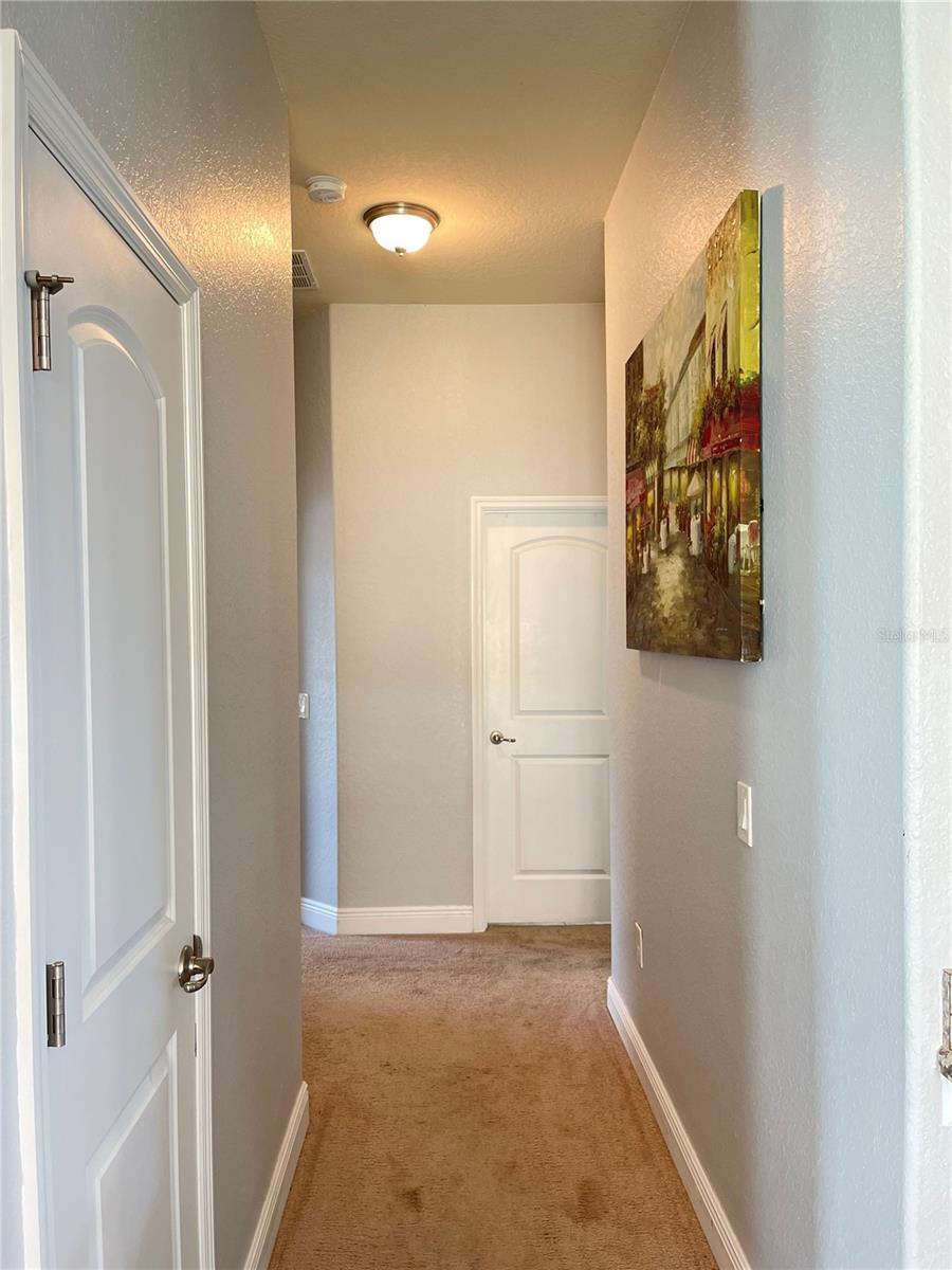 hallway to the additional bedrooms and guest bathroom