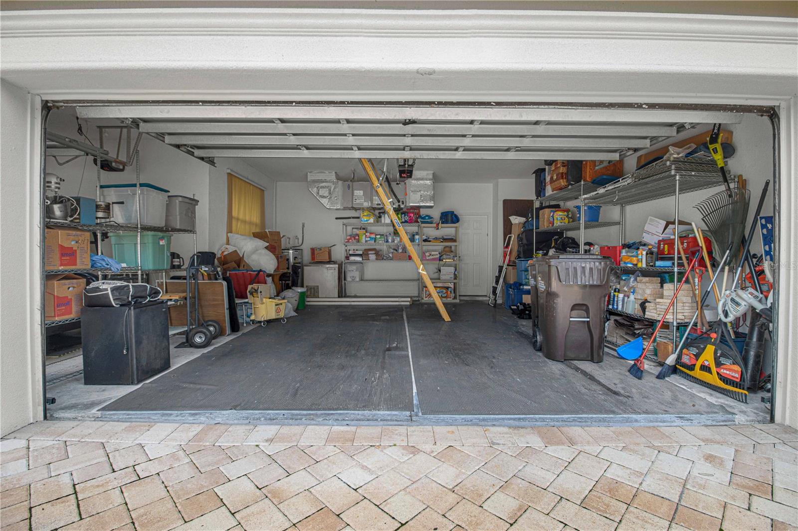 Garage has pull down steps into the attic space. Leaving 5-metal storages shelving.