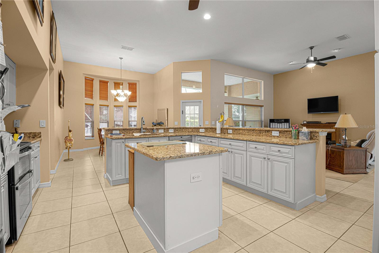 high ceiling, island in the middle plenty of working space in the kitchen several outlets for small appliances.