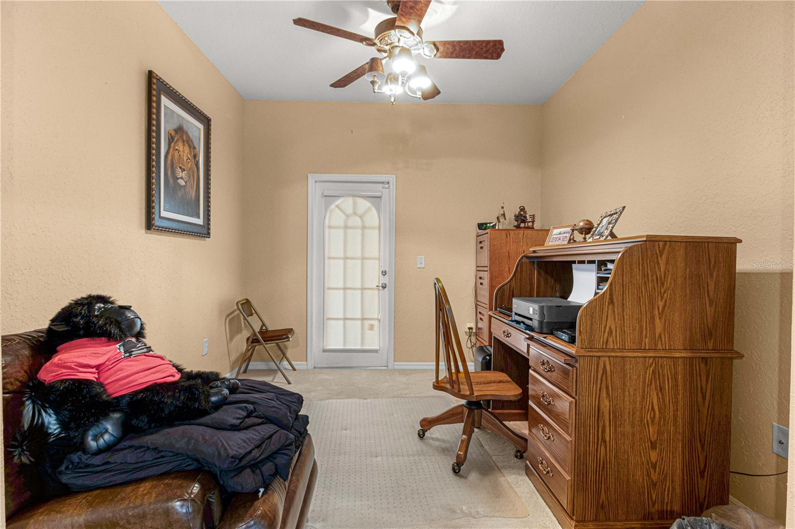 study room inside the primary bedroom separate room leading to the pool area. Ceiling fan, high ceiling, carpet. Great for reading or office space.