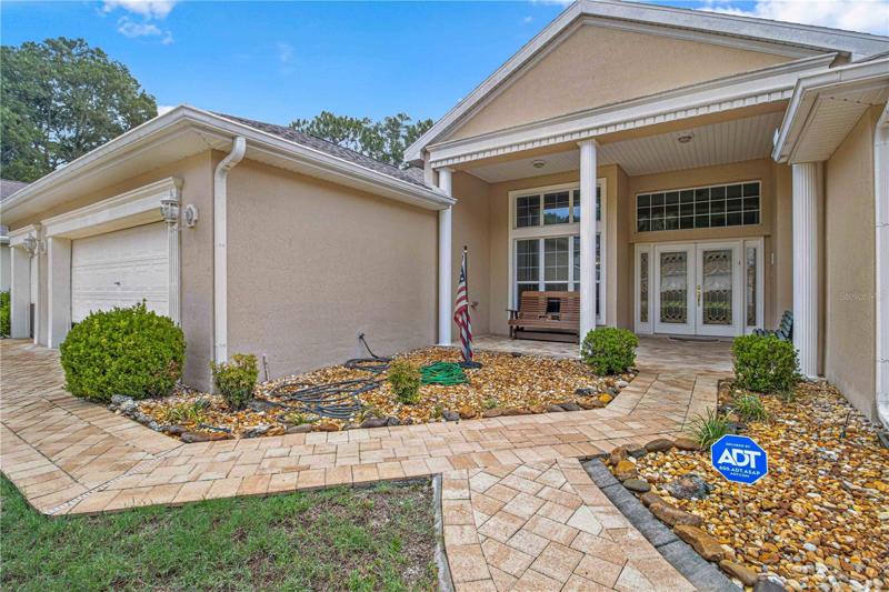 Main entrance of the house, high columns, front porch, french doors, high ceiling.