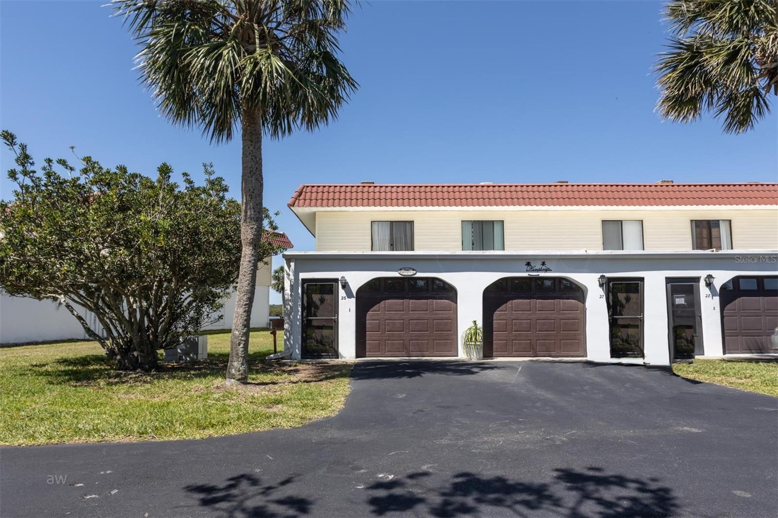 Main entry with parking space and storage garage.