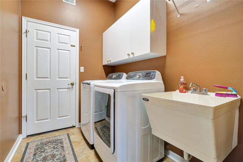 Inside laundry room includes that washer and dryer with steam function.