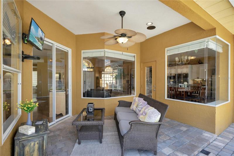 Covered and screened lanai with upgraded brick pavers.