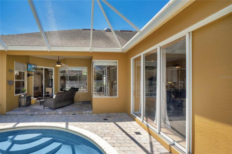 Collapsible sliding glass doors from the family room to the screened pool and covered lanai making this the perfect area to entertain your guests.