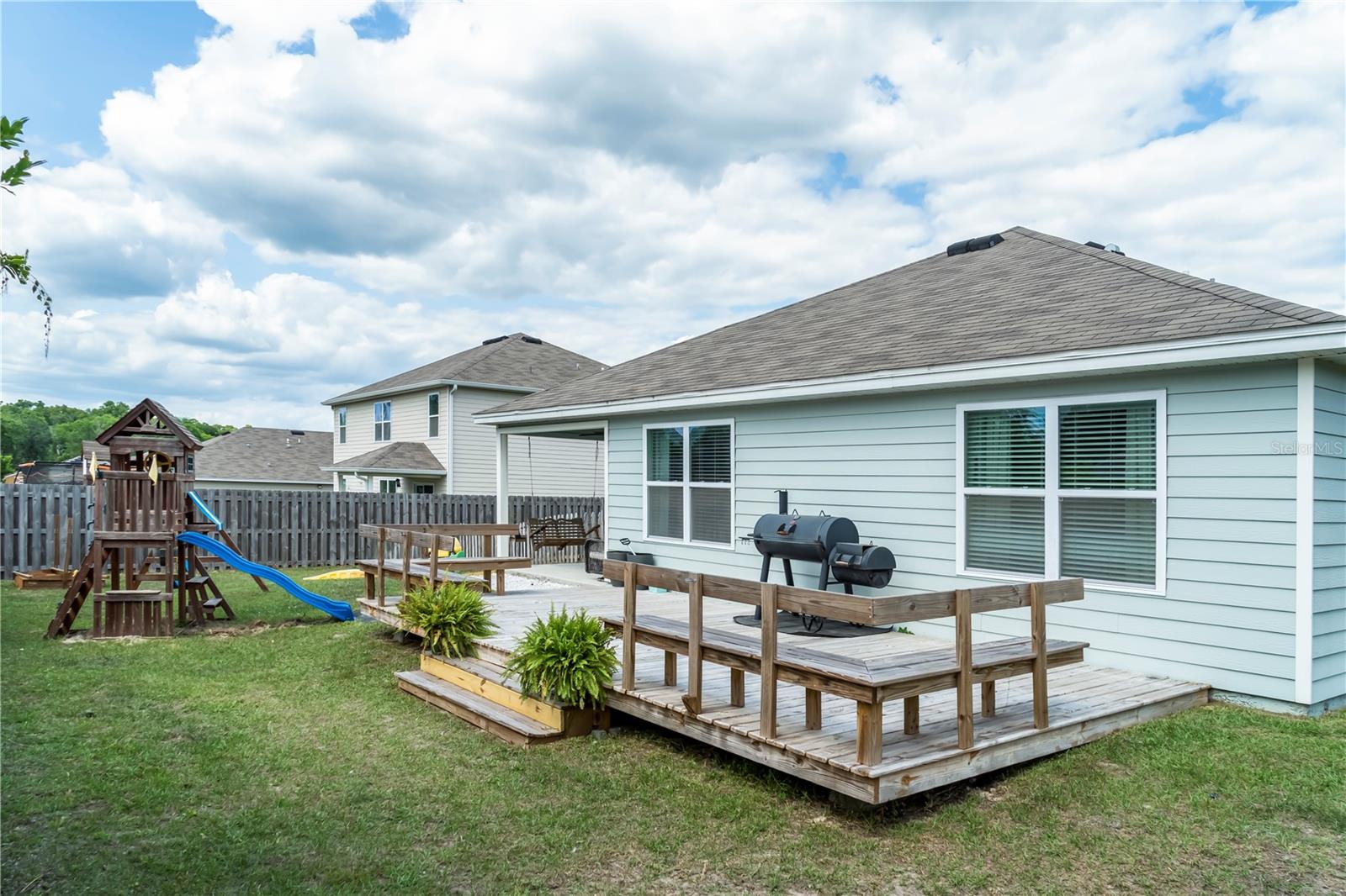 Large backyard with children's play area.