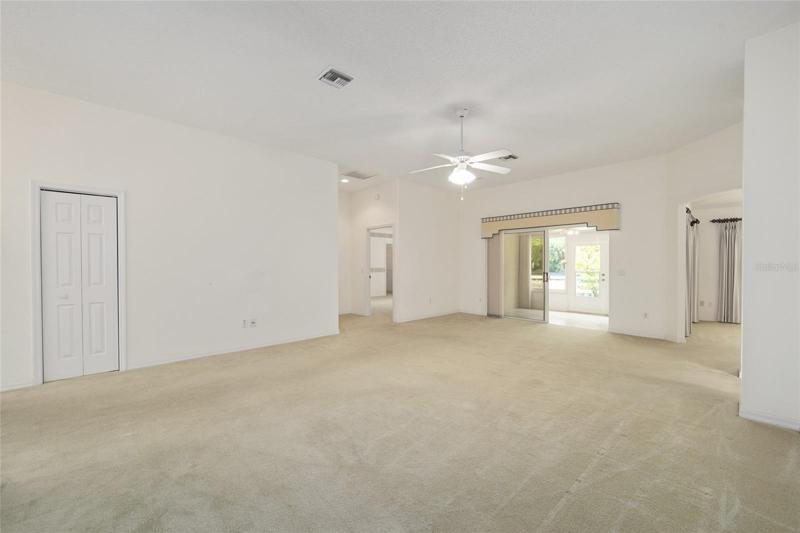 LIVING ROOM - View from front corner shows COAT CLOSET on L
