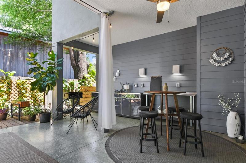 Communal outdoor area with summer kitchen and charcoal grill