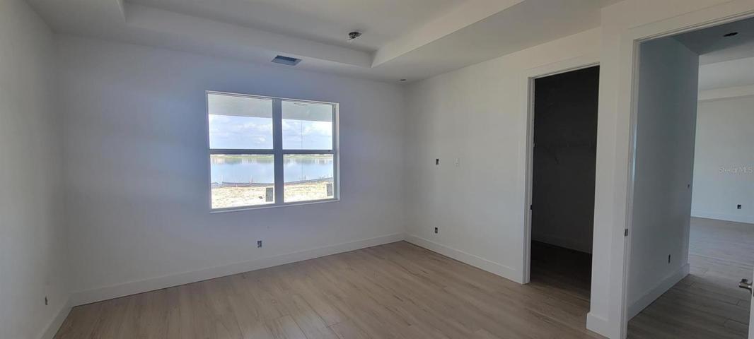 Primary bedroom with tray ceiling- walk-in closet to the side
