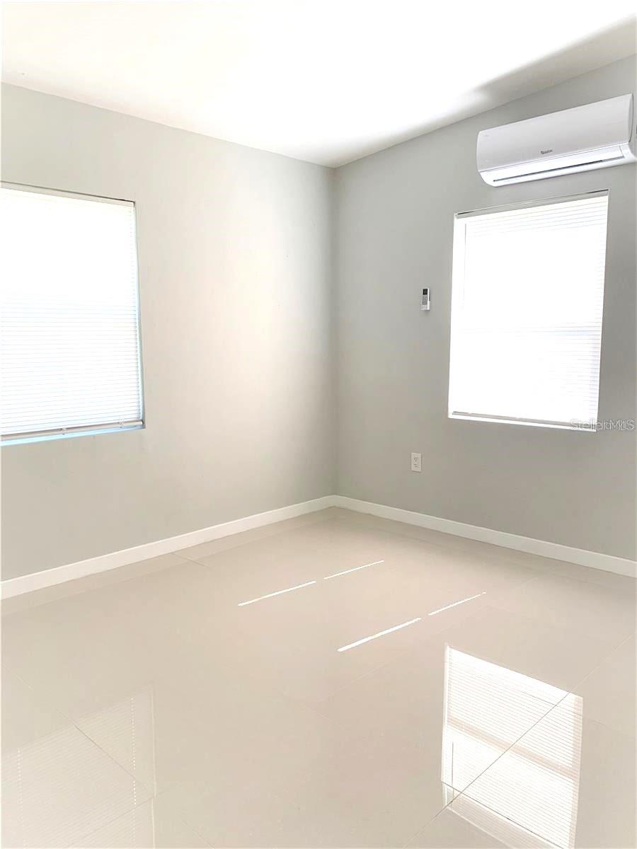 bedroom 1 with new high efficiency mini split AC with remote for ease of use.